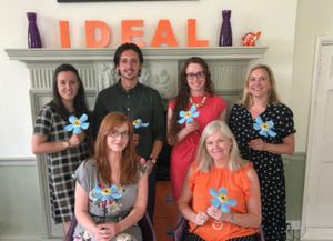 Harborough marketing team with forget me not flowers